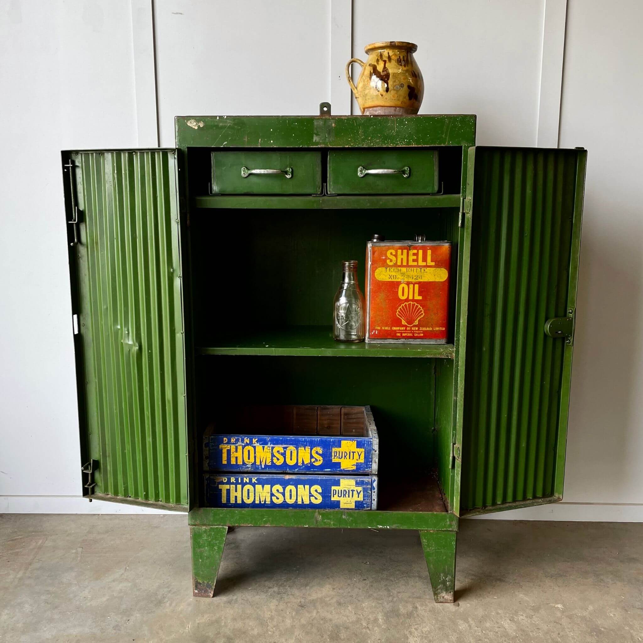 Vintage industrial storage cabinet with shell oil can